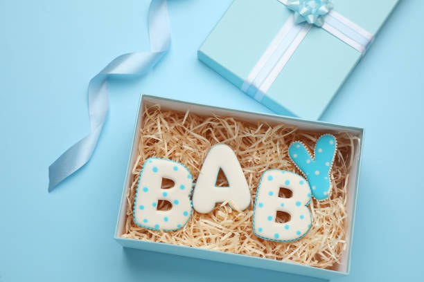 Baby shower gift box on turquoise background