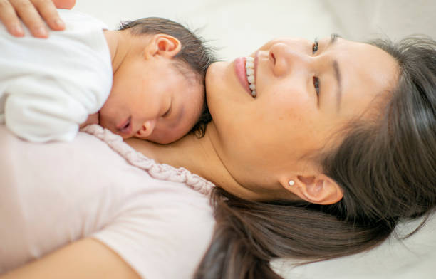 parent gently holding a baby