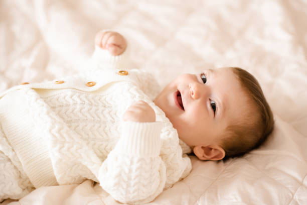 Clean, neatly folded baby tops after gentle washing.
