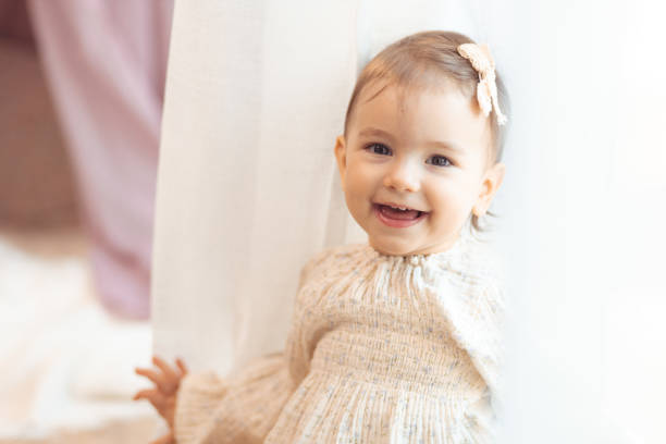 Baby comfortably dressed in a cotton dress during playtime.