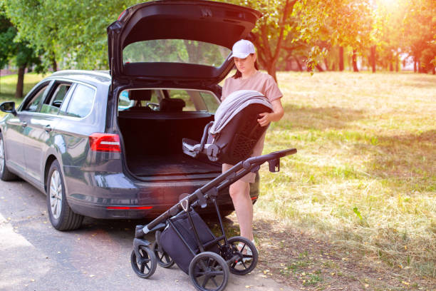 Parent using a travel system to move baby from car to stroller, showcasing a travel-friendly combo for parents.