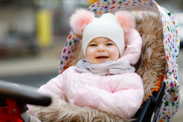 Baby wearing a puffer jacket outdoors in cold weather.