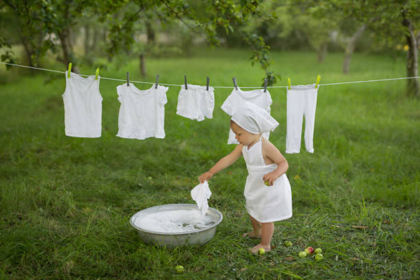 Washing a delicate baby dress with gentle baby-safe detergent.
