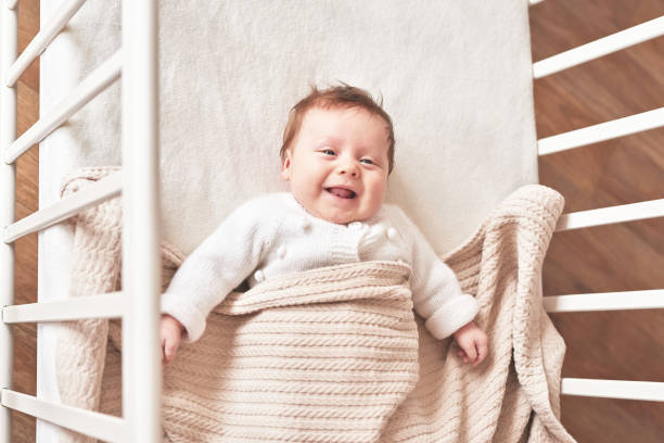 Baby wearing a cozy cotton cardigan while sleeping peacefully.