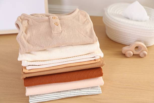 Baby cardigans in pastel pink, sage green and mustard yellow trending colors.