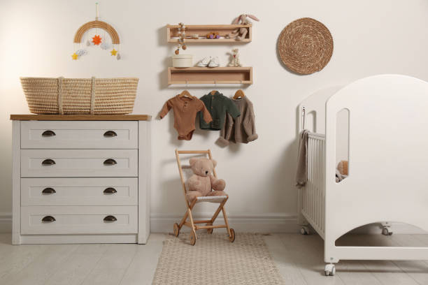 "A modern, gendbaby nursery with earth tones, wooden furniture, a botanical wall mural, and eco-friendly decor accents like rattan baskets and organic fabrics.