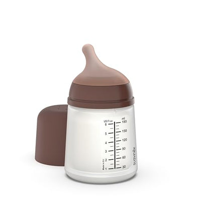 Baby bottle with brown cap and base on a white background