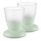 Two green baby cups with white tops on a white background