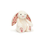 Floral-patterned plush bunny toy on a white background
