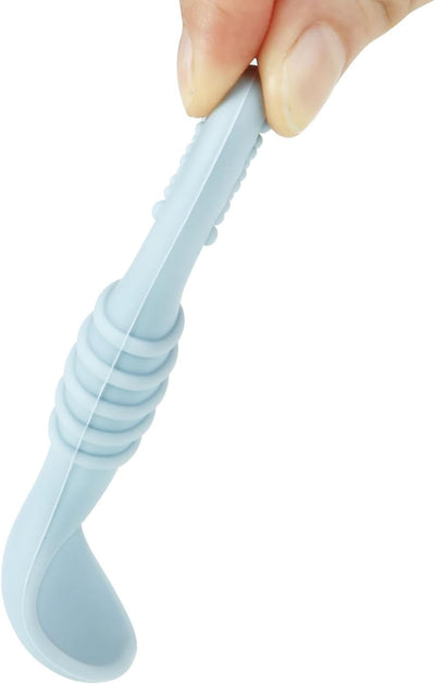 Light blue silicone tool held by a hand on a white background