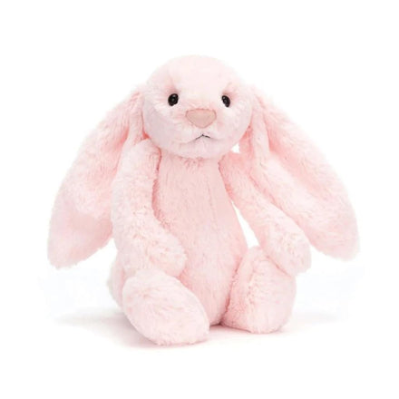 Pink plush bunny toy on a white background