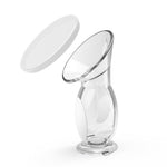 Clear breast pump with a white cover on a white background