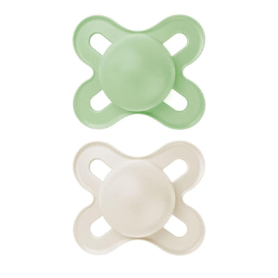 Two green and white baby pacifiers on a white background