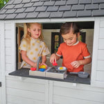 KidKraft Riverscape Wooden Playhouse with Working Doorbell, Fence, Kitchen and Pet Door