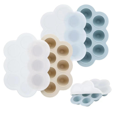 Set of silicone ice cube trays in various shapes on a white background