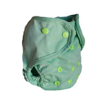Green cloth diaper with button closures on a white background