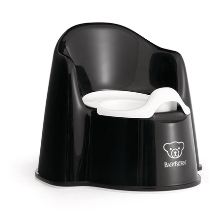 Black potty chair with white seat on a white background, featuring the BABYBJöRN logo.
