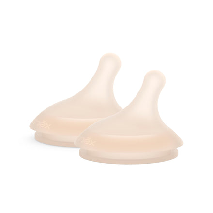 Two beige silicone baby bottle nipples on a white background