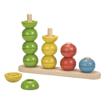 Colorful wooden stacking toy with multiple levels on a white background