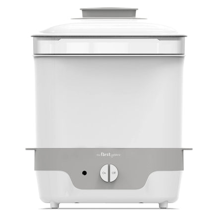 White and gray baby bottle sterilizer with 'The First Years' branding on a white background