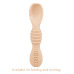 Beige baby spoon with textured handle on a white background