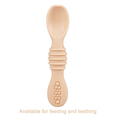 Beige baby spoon with textured handle on a white background