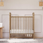 Namesake Abigail 3-in-1 Portable Baby Crib with Wheels - GREENGUARD Gold Certified Convertible Crib to Toddler Bed & Daybed - Metal Baby Bed w/ 4 Adjustable Mattress Heights, for Small Spaces - Gold