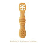 Yellow baby teething toy on a white background
