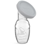 Handheld silicone breast pump with a gray cover on a white background