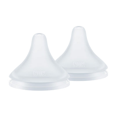 Two white silicone sippy cup lids on a white background