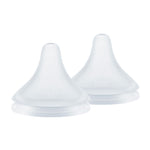 Two white silicone sippy cup lids on a white background