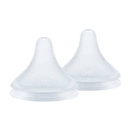 Two white silicone sippy cup lids on a white background