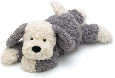 Plush toy dog with gray and white fur on a white background