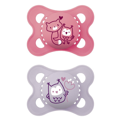 Two baby pacifiers, one pink and one purple, with owl designs on a white background.