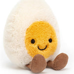 Plush toy resembling a boiled egg with a smiling face on a white background