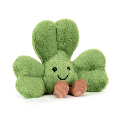 Green plush toy with a smiling face on a white background