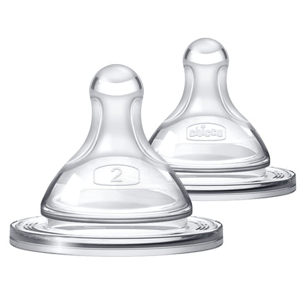 Two clear baby bottle nipples on a white background