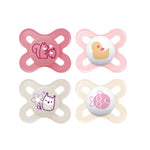 Four pink and beige baby pacifiers with animal designs on a white background