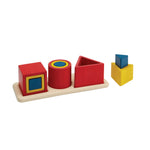 Colorful geometric shape sorting toy on a white background