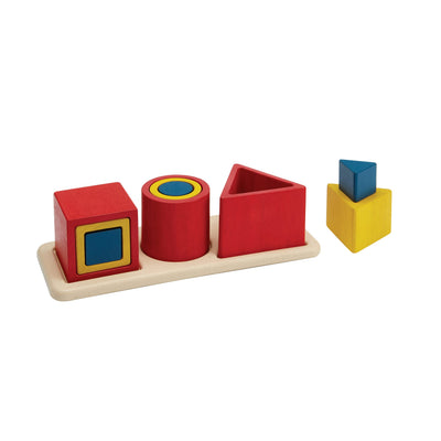Colorful geometric shape sorting toy on a white background