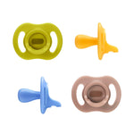 Four colorful baby pacifiers on a white background