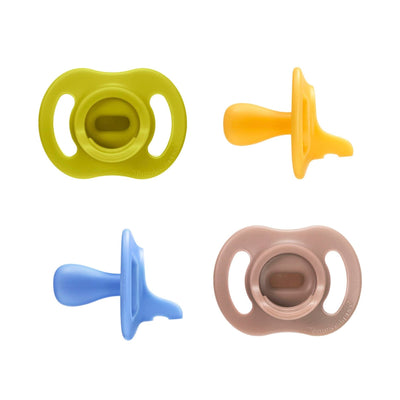 Four colorful baby pacifiers on a white background