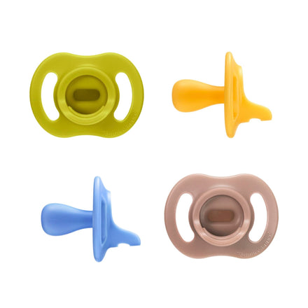 Four colorful baby pacifiers on a white background