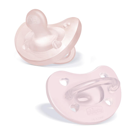 Two pink baby pacifiers on a white background