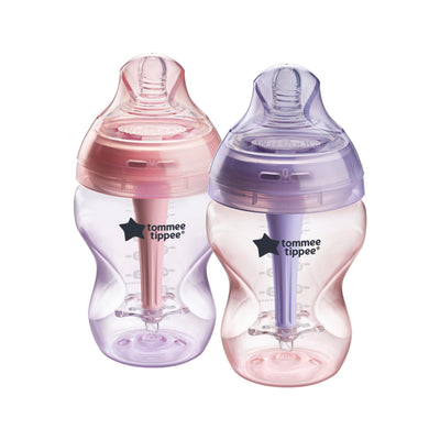 Two baby bottles with pink and purple accents on a white background, featuring the Tommee Tippee logo.
