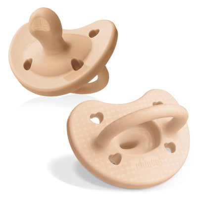 Two beige pacifiers on a white background