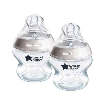 Two Tommee Tippee baby bottles on a white background