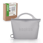 Gray silicone steamer bag with 'haakaa' branding and packaging in the background.