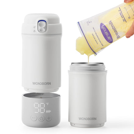 Wondborn temperature display cup with a hand pouring liquid into it on a white background