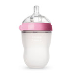 Baby bottle with pink cap and white body on a white background
